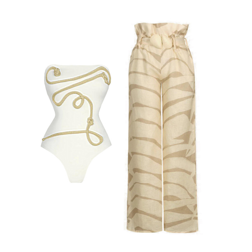 Der Jassyy Bodysuit von CozyWoolCraft in Weiß-Gold mit kunstvoller Seilapplikation betont elegant die Silhouette und steht für luxuriösen Stil.