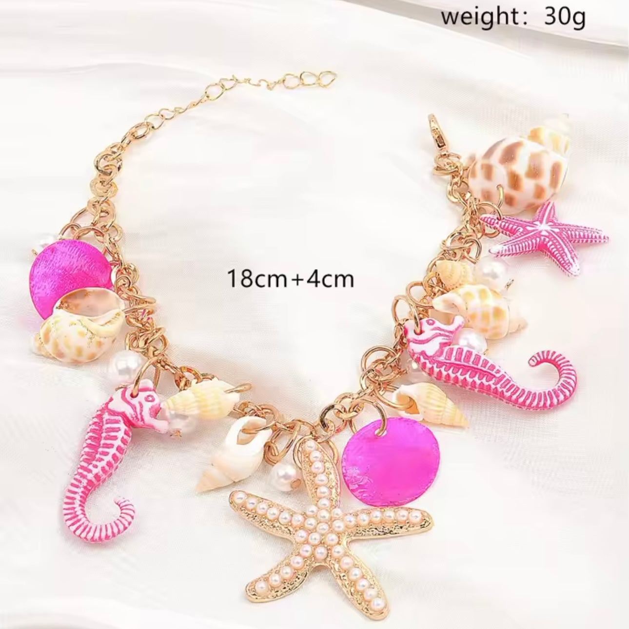 Maritimes Armband in Pink-Gold mit Seepferdchen, Seestern und Muscheln, inspiriert vom Ozean – handgefertigter Schmuck von CozyWoolCraft.