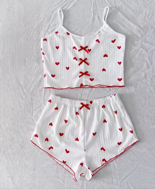 Weißes Pyjama Set mit roten Herzen und Schleifendetail, weiches Cami-Top mit Shorts aus geripptem Stoff, cozy und feminin.